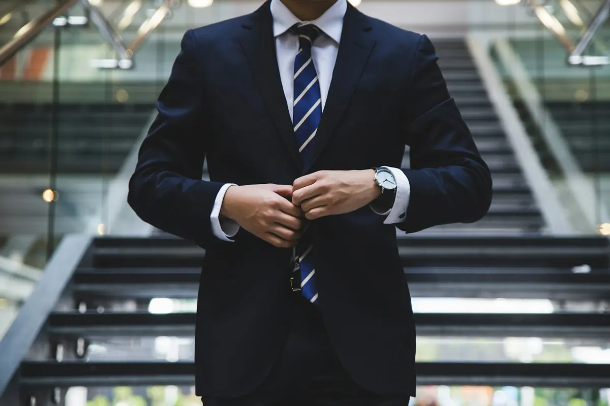Professional in a navy suit, ready for a consultation