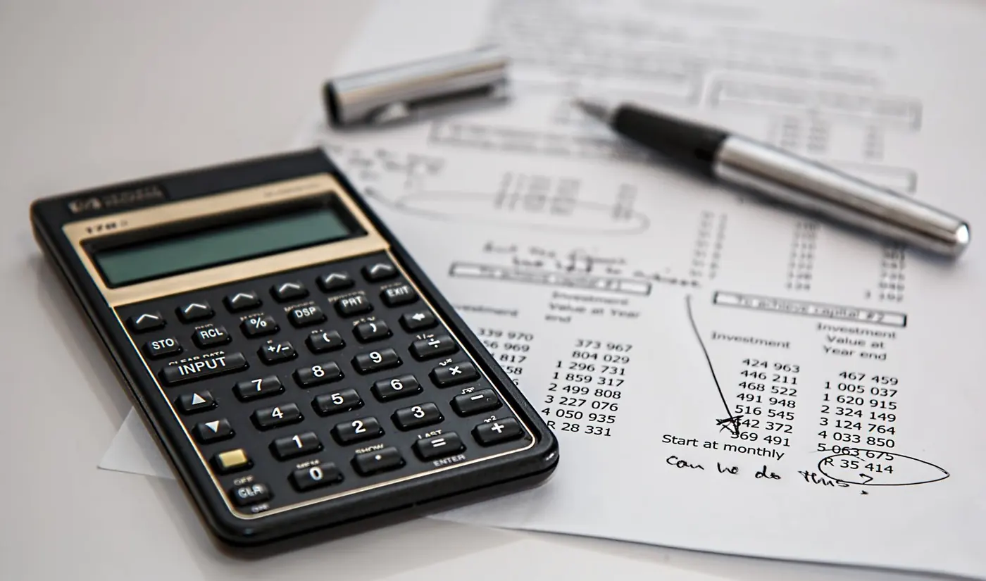 Financial calculator and investment report on a desk
